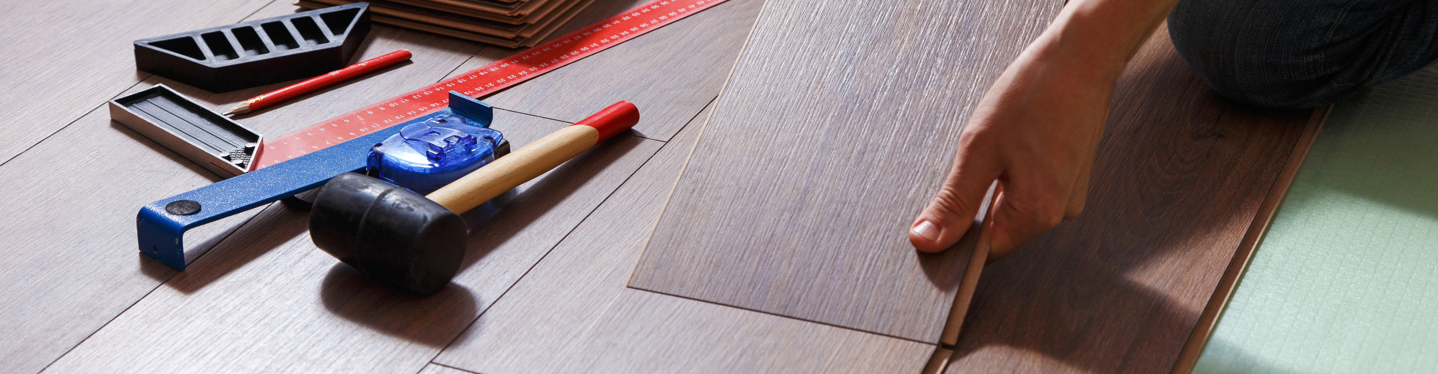 Hands installing flooring planks closeup. 